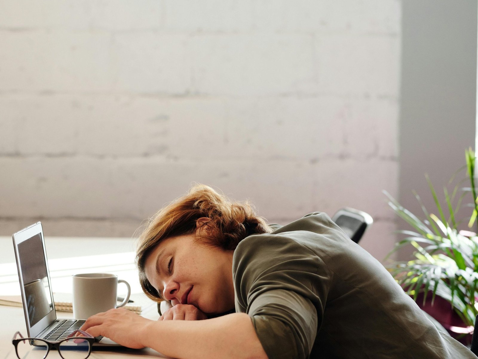 Photo of Woman Leaning on Her Desk